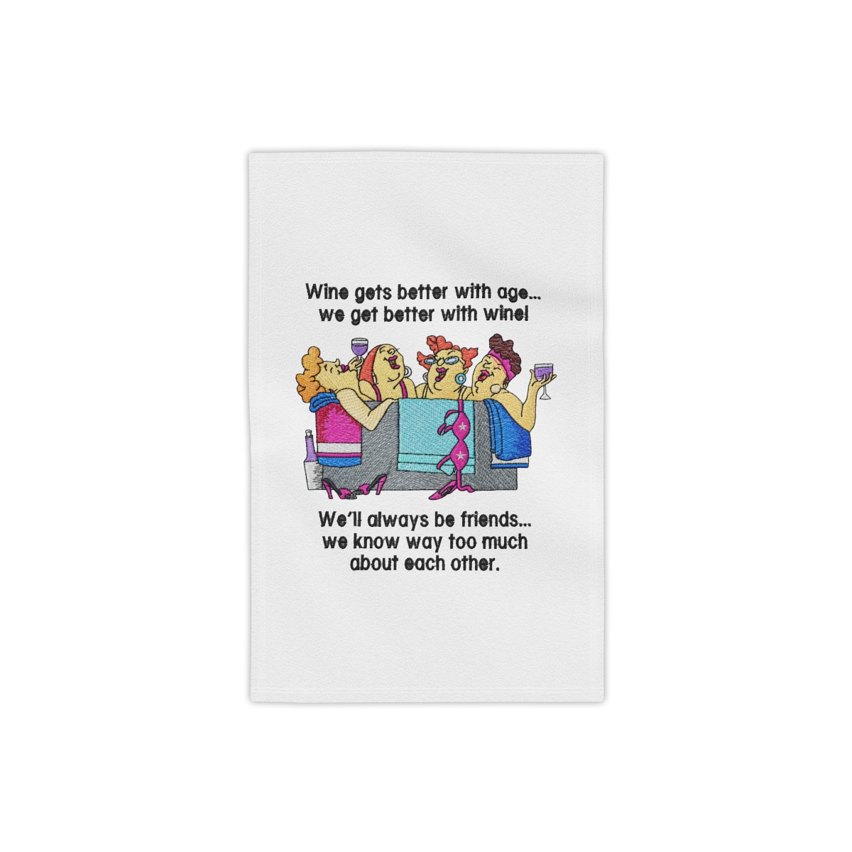 white towel with a humorous design. The image features four cartoon women in a tub, holding wine glasses. Text reads "Wine gets better age... we get better wine!" and "We'll always be...